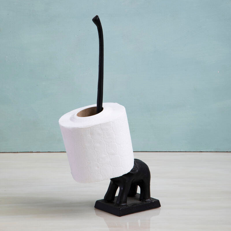 Black elephant-shaped toilet brush holder with a roll of white toilet paper on a light gray background