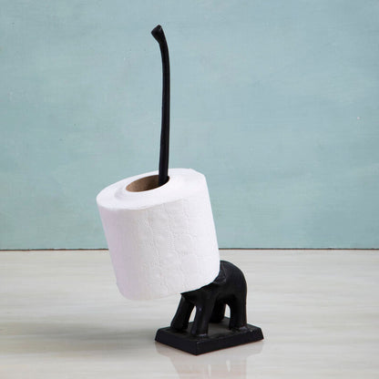 Black elephant-shaped toilet brush holder with a roll of white toilet paper on a light gray background