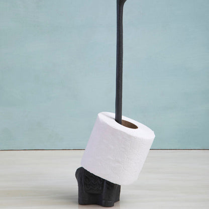 Black toilet brush with holder and white toilet paper on a light gray background