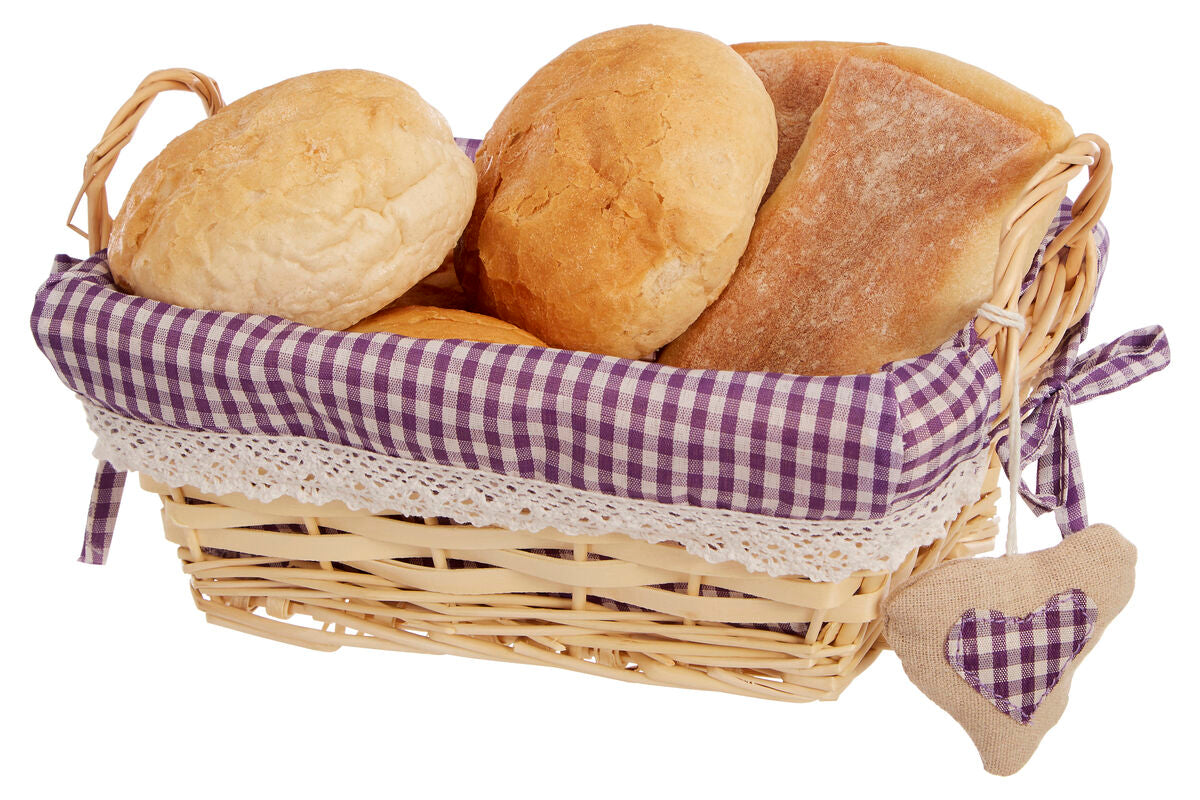 Basket of bread with a purple checkered lining on a white background