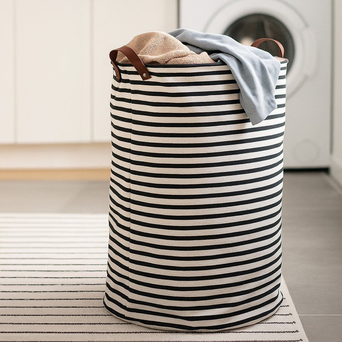 Striped laundry basket with clothes inside in a laundry room.