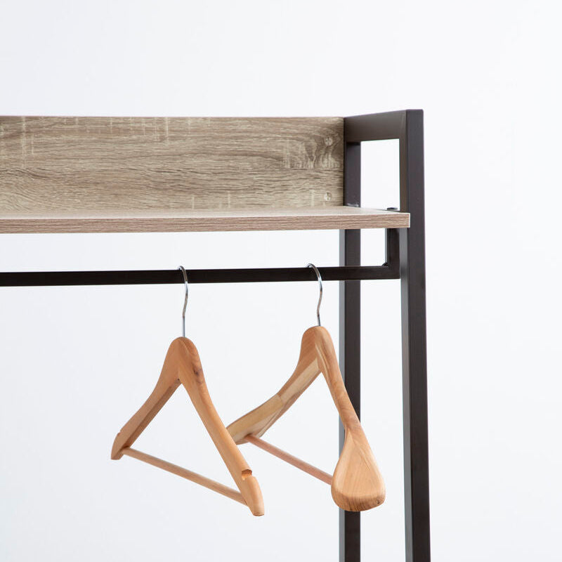Wooden hangers on a metal rack with a neutral background