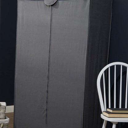 Gray folding wardrobe against a dark wall with a white chair and books on it.