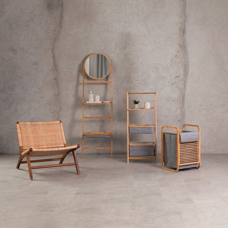 Rattan furniture set including a chair, shelves, and a bench against a concrete wall.