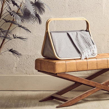 Wooden bench with a gray bag on a beige wall background