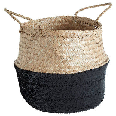 Woven basket with natural top and black bottom on a white background