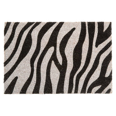Zebra patterned rug with black and white stripes on a plain background