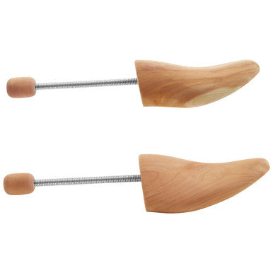 Pair of wooden shoe trees on a white background
