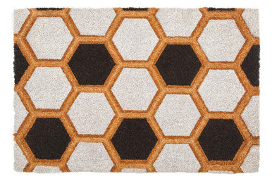Hexagonal patterned rug with brown and black hexagons on a white background