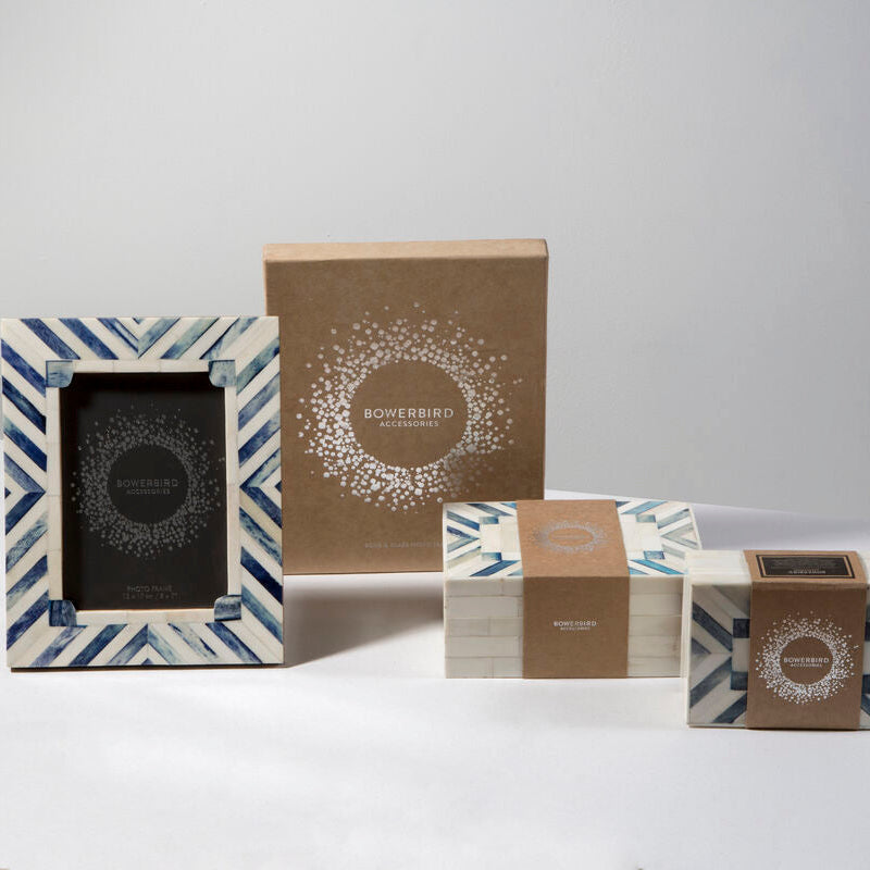 Set of decorative boxes with geometric patterns on a white surface