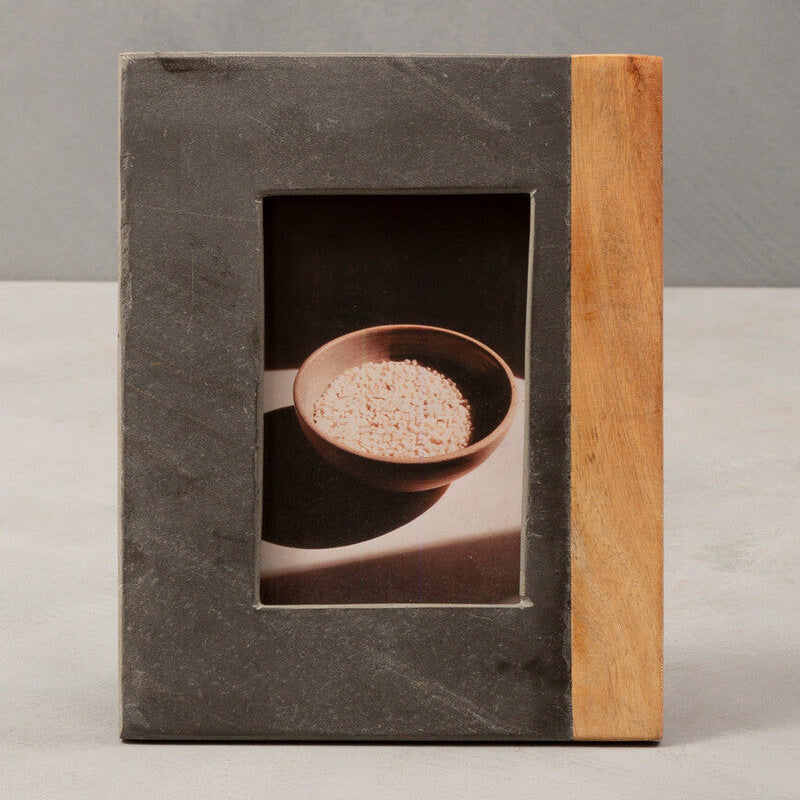 Rectangular photo frame with a dark stone front and wooden sides on a neutral background