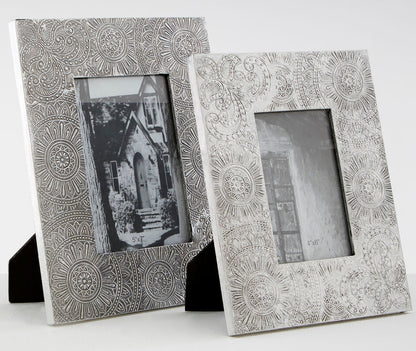 Two decorative silver photo frames on a white background