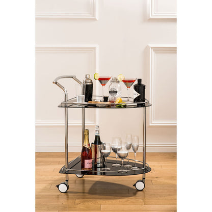 Bar cart with drinks and glasses on a wooden floor.