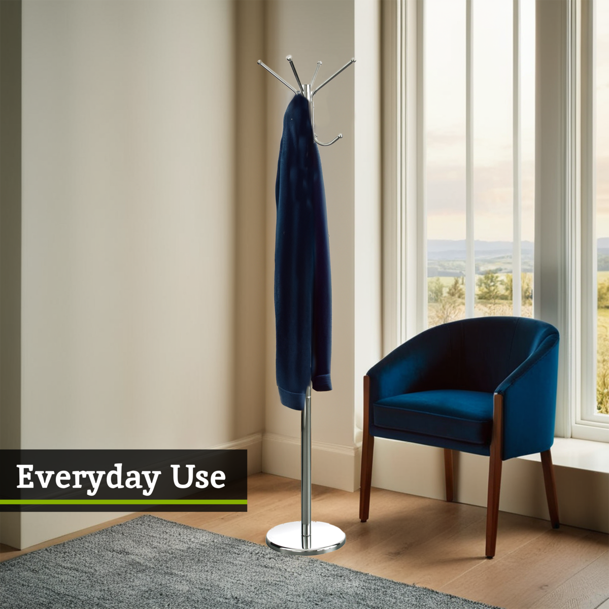 Hoodie on a stand next to a blue chair in a room with large windows.