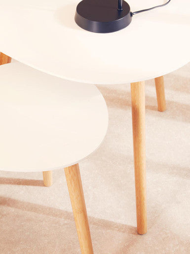 White stool with wooden legs on a beige carpet