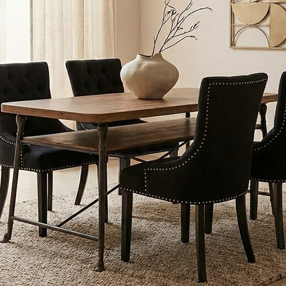 Dining room with wooden table and black chairs on a beige rug.