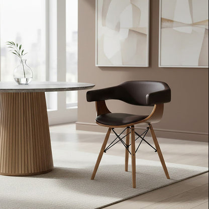 Modern dining room with a round table and chair, abstract art on the wall.