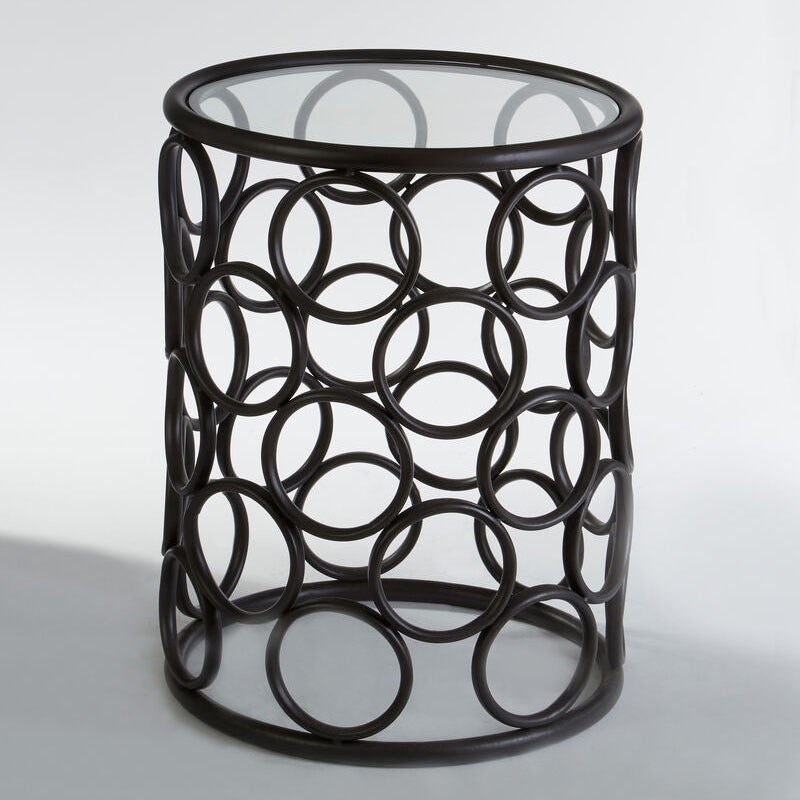 Decorative side table with circular metal design on a white background
