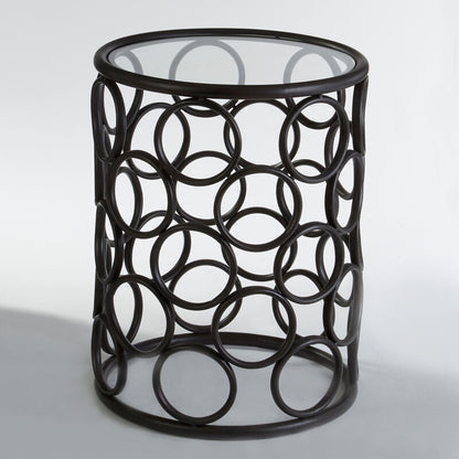 Decorative side table with circular metal design on a white background