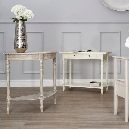 Three white console tables with decorative items against a gray wall.