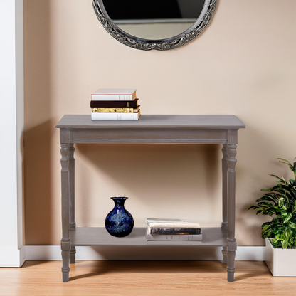 Gray console table with decorative items against a beige wall