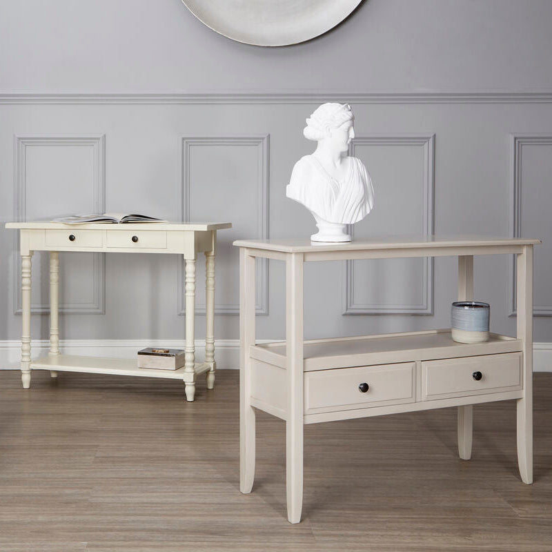 Three white console tables with decorative items against a gray wall.