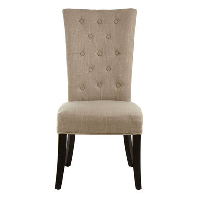 Beige upholstered chair with button tufting on a white background