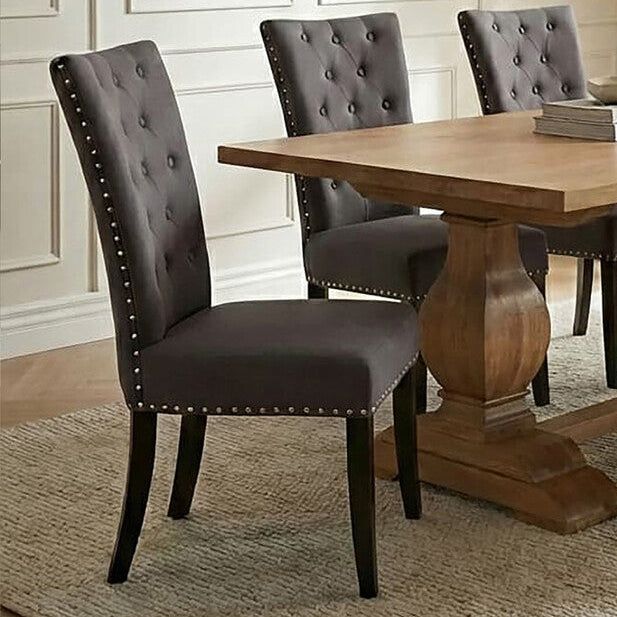 Dining room with wooden table and gray chairs in a well-lit room.