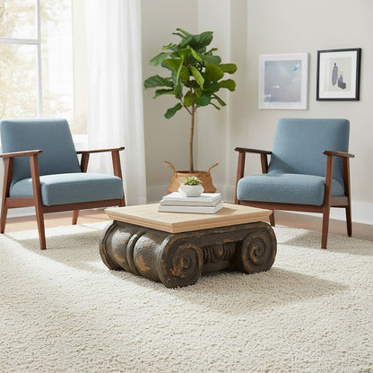 Living room with blue armchairs, a wooden coffee table, and a plant.