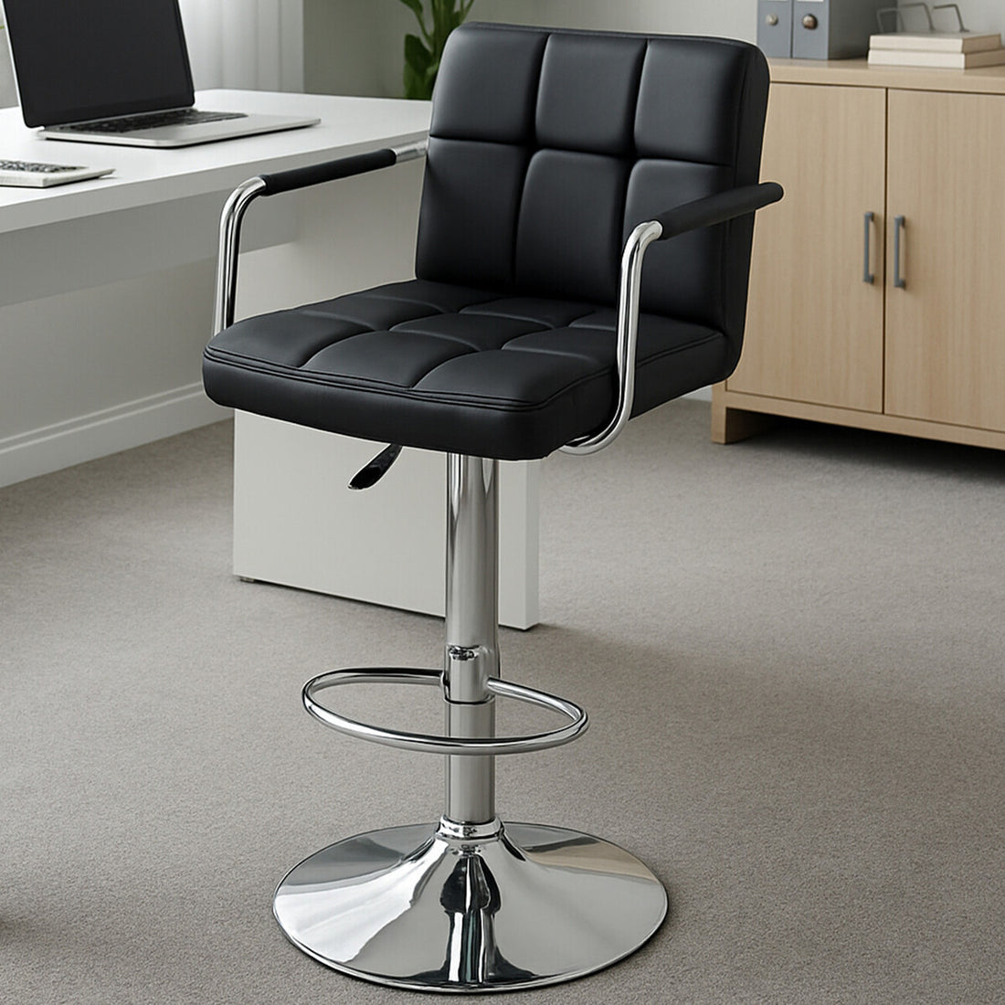 Black bar stool with chrome base in an office setting
