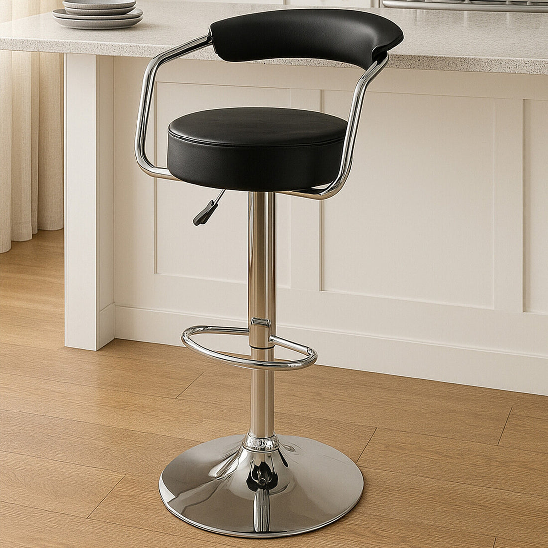 Black bar stool with chrome base in a kitchen setting