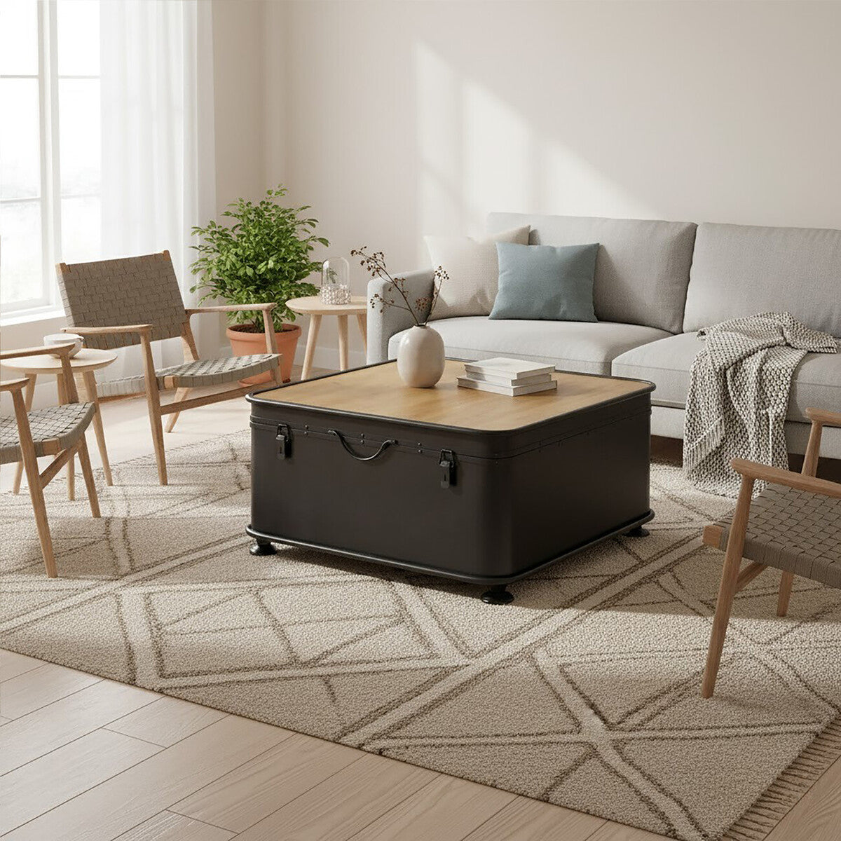 Living room with a large black coffee table, gray sectional sofa, and wooden chairs.