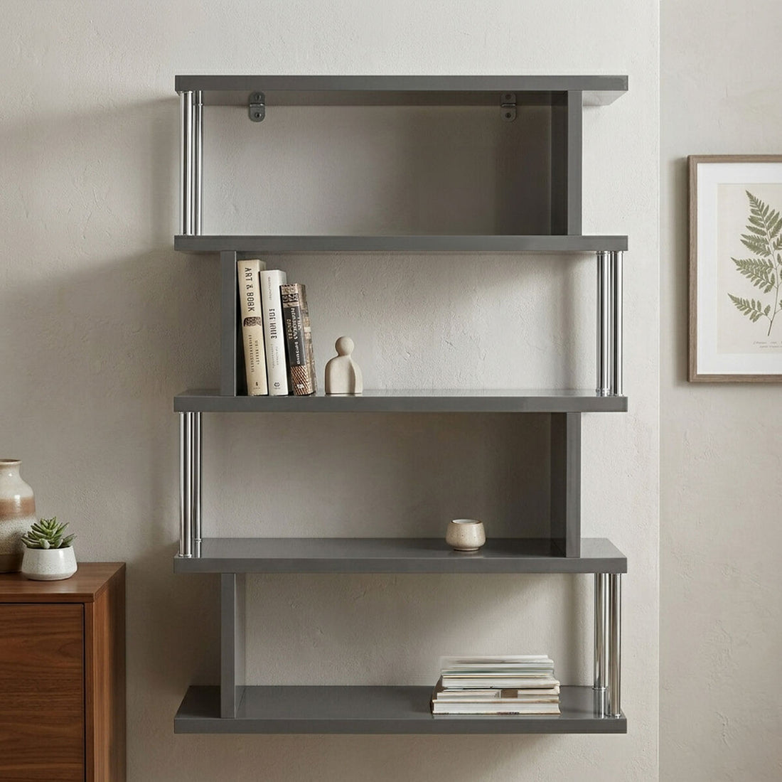 Gray wall-mounted bookshelf with books and decor items against a neutral wall.