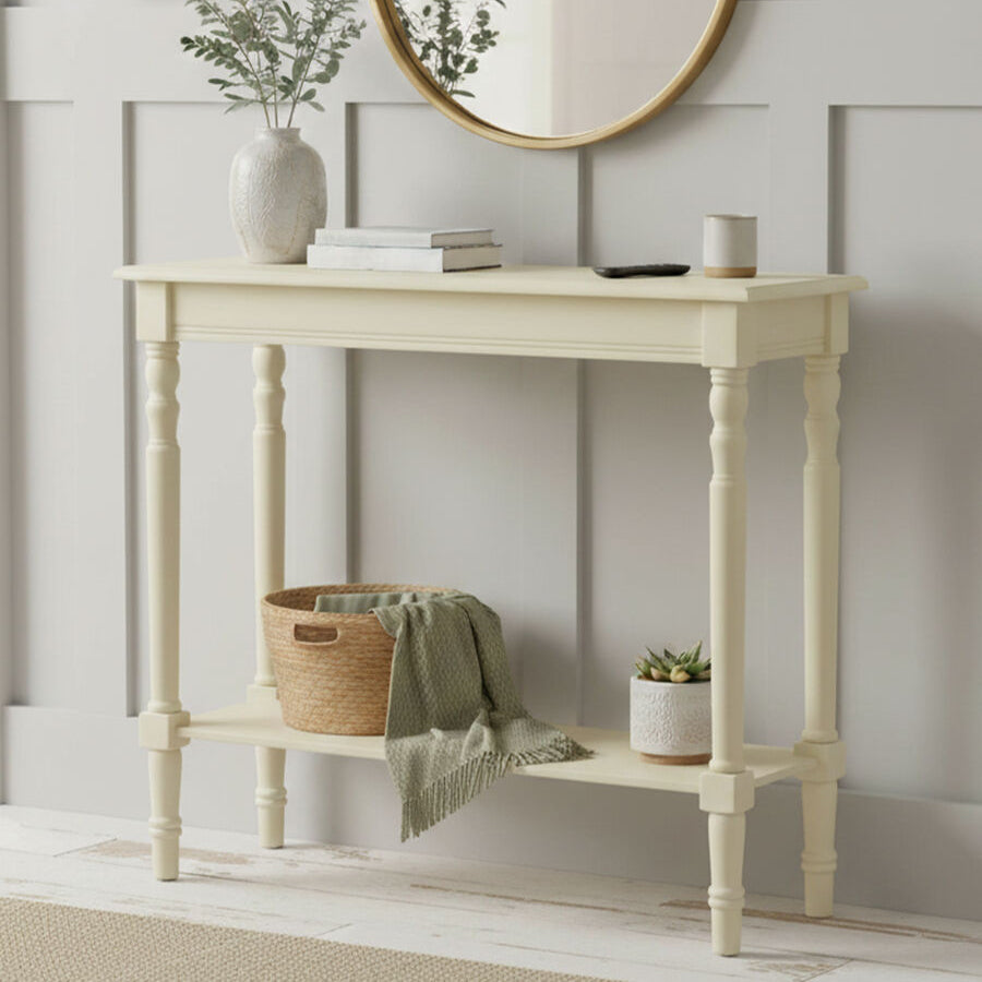 Light-colored console table with decorative items against a neutral wall.
