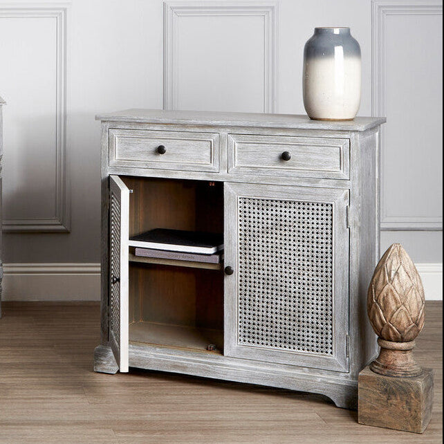 Gray wooden furniture set with a bench, sideboard, and cabinet in a room with white walls and wooden floor.
