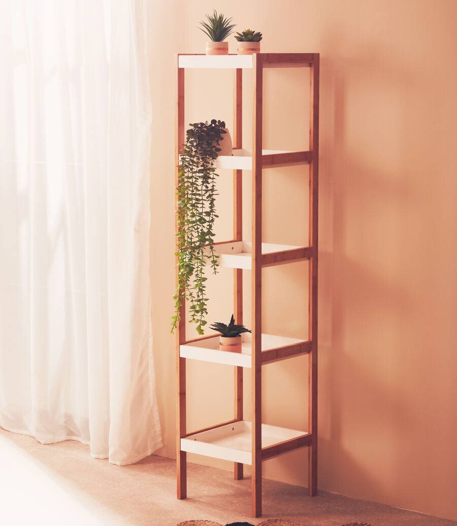 Wooden shelf with plants against a beige wall