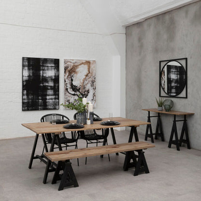 Modern dining area with wooden tables and benches against a concrete wall.