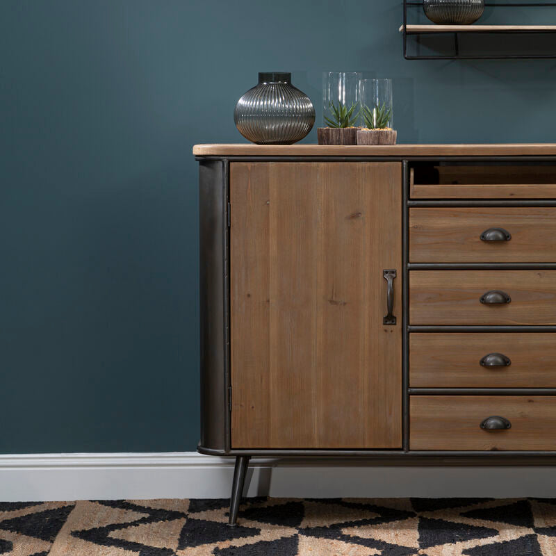 Wooden sideboard with decorative items against a dark blue wall.