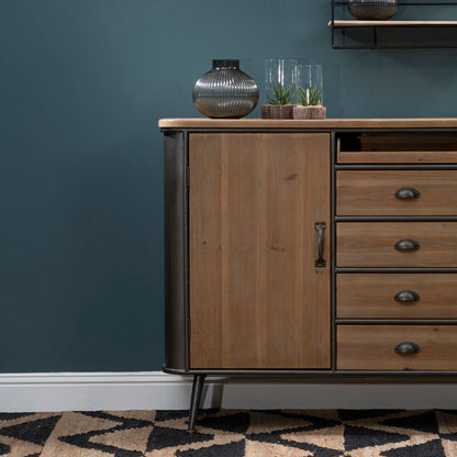 Wooden sideboard with decorative items against a dark blue wall.