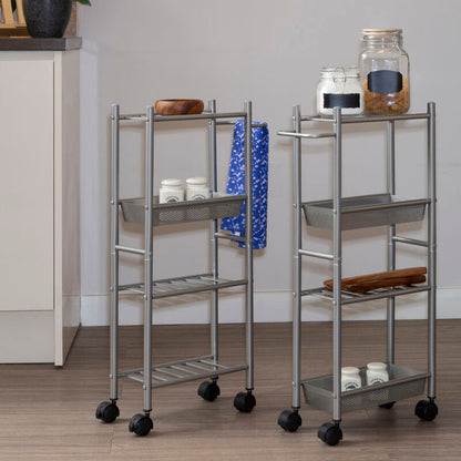 Two metal serving carts with wheels on a wooden floor against a gray wall.
