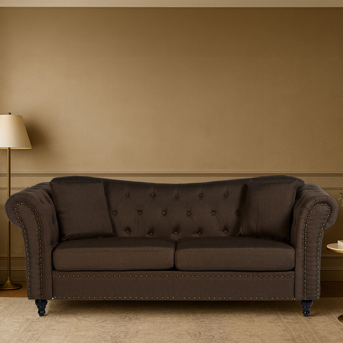 Brown sofa in a room with a beige wall and lamp.
