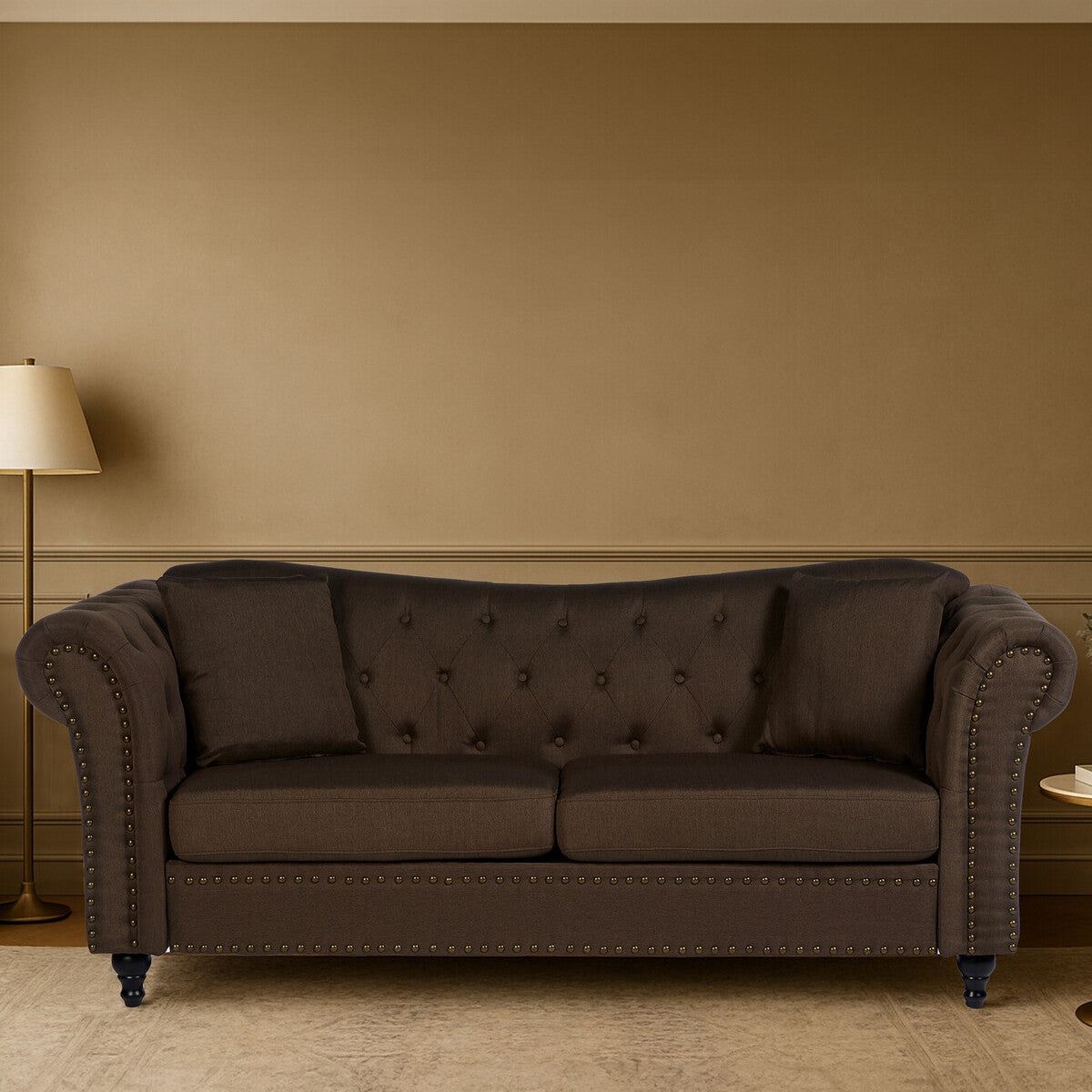 Brown sofa in a room with a beige wall and lamp.