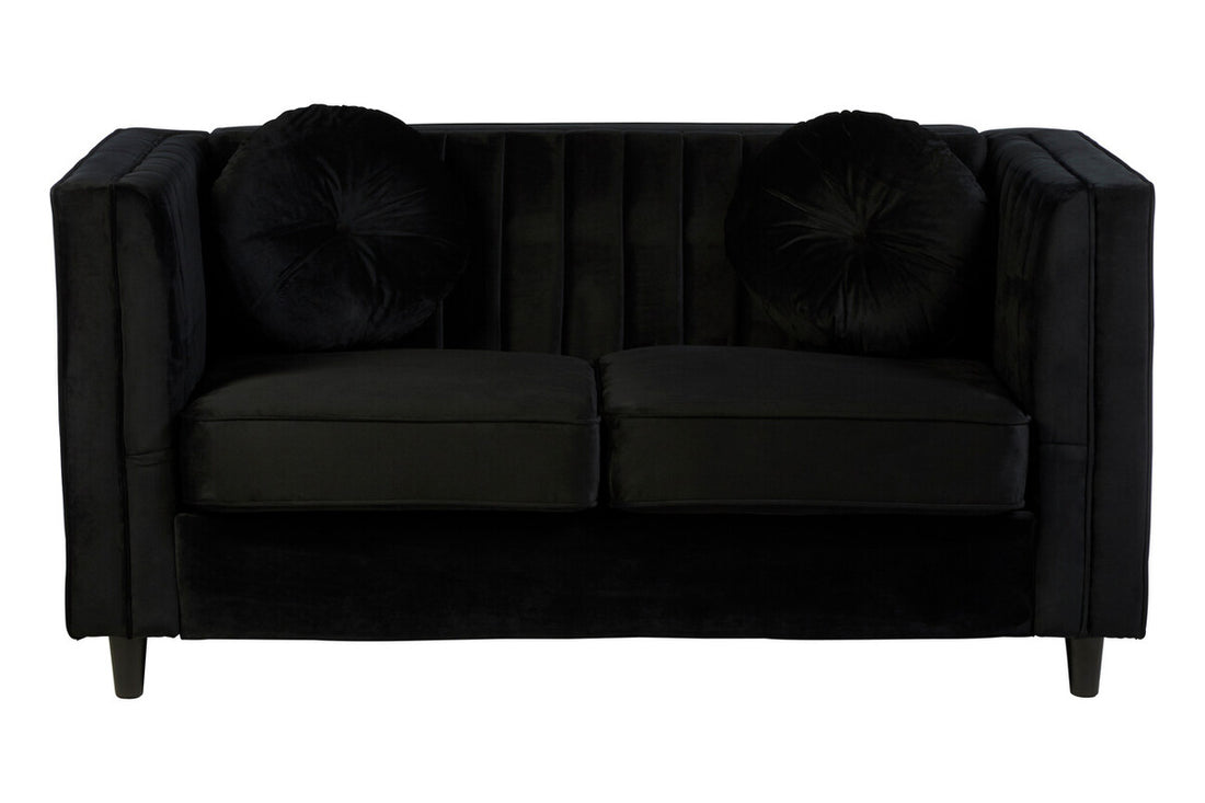Black sofa with decorative cushions on a white background