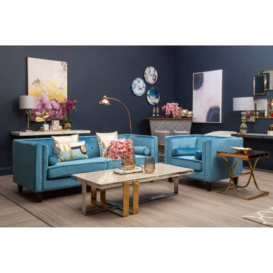 Blue sofa set in a living room with decorative elements and wall art.