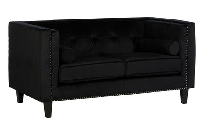 Black tufted sofa with nailhead trim on a white background