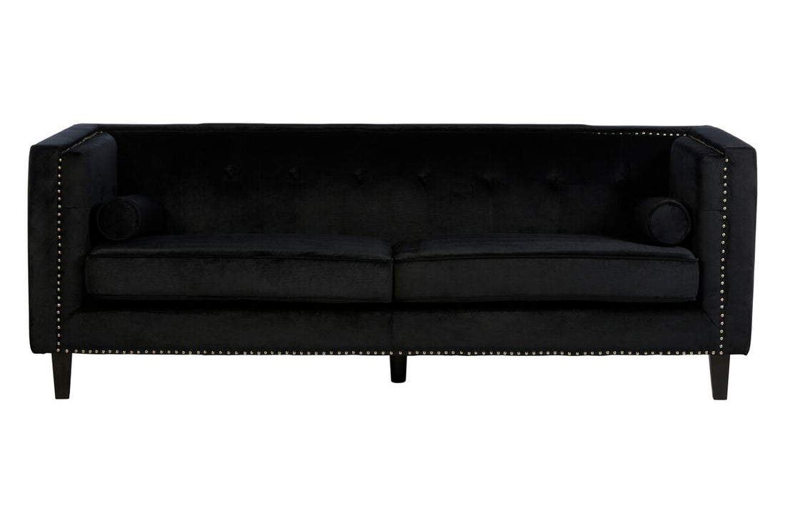 Black sofa with nailhead trim on a white background