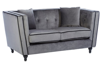 Gray velvet sofa with tufted backrest on a white background