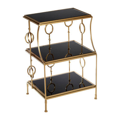 Three-tiered metal table with black glass shelves on a white background