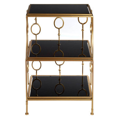 Three-tiered gold and black shelf with decorative rings on a white background