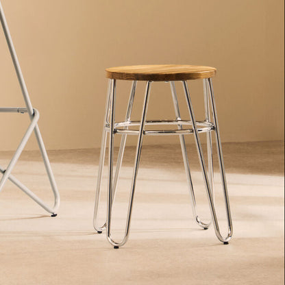 Two stools with metal frames and wooden seats in a minimalistic setting.